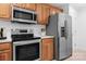 Updated kitchen features stainless steel appliances, wood cabinets, and bright countertops at 753 Southwest Dr, Davidson, NC 28036