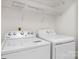 Bright laundry room with washer, dryer, and shelving at 753 Southwest Dr, Davidson, NC 28036