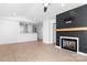 Open living room with fireplace and kitchen bar at 753 Southwest Dr, Davidson, NC 28036