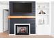 Close up of fireplace and built in shelving in living room with hardwood floors at 753 Southwest Dr, Davidson, NC 28036