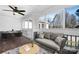 Cozy sunroom with wood floors, ceiling fan, cushioned seating, and a view of the yard at 753 Southwest Dr, Davidson, NC 28036