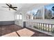 Enclosed porch features wood floors, wide view windows, and white paneled walls at 753 Southwest Dr, Davidson, NC 28036