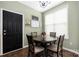 The dining area features a decorative light fixture, a window, and a dark-colored door at 7602 Rolling Meadows Ln, Huntersville, NC 28078