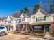 Neat row of townhouses with green accents and ample parking at 7677 Petrea Ln # 2904, Charlotte, NC 28227