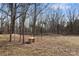 Backyard features a stone bench in a partially wooded area with natural light at 87 Firemens Ln, Taylorsville, NC 28681