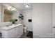 Bright bathroom features a double sink vanity with framed mirror and decorative towel racks at 87 Firemens Ln, Taylorsville, NC 28681