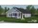 Single-story home featuring light blue siding, a welcoming front porch, and a well-maintained lawn at 0 Shaver St # 3, Salisbury, NC 28144
