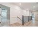 Upstairs hallway with modern railings and hardwood floors at 01 Mcfalls Dr, Indian Land, SC 29707