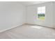 Bright bedroom with neutral carpet and a window providing natural light and a view of the outside at 10115 Mamillion Dr, Huntersville, NC 28078