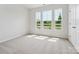 Inviting bedroom filled with natural light from three large windows and carpeted floor at 10115 Mamillion Dr, Huntersville, NC 28078