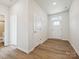 Bright entryway with wood-look floors, white trim, and a conveniently located half bathroom at 10115 Mamillion Dr, Huntersville, NC 28078