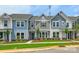 Charming townhome with a well-manicured lawn, colorful facade, and inviting curb appeal at 10115 Mamillion Dr, Huntersville, NC 28078