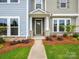 Inviting front entrance features a walkway, stylish door, and well-maintained landscaping at 10115 Mamillion Dr, Huntersville, NC 28078