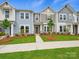 Charming two-story townhome with landscaped front yard and walkway leading to the front door at 10115 Mamillion Dr, Huntersville, NC 28078