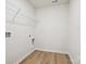 Bright laundry room with wood-look flooring and white walls with utility connections at 10115 Mamillion Dr, Huntersville, NC 28078
