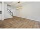 Open concept living space with stylish light fixture and stairs at 10115 Mamillion Dr, Huntersville, NC 28078