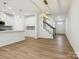 Open-concept living space with island, view of stairs, and lots of natural light at 10115 Mamillion Dr, Huntersville, NC 28078