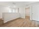 Upstairs loft space with wood-look floors, bright and airy with multiple doorways at 10115 Mamillion Dr, Huntersville, NC 28078