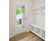 Convenient mud room with bench seating, storage cubbies, and a door leading to the backyard at 10115 Mamillion Dr, Huntersville, NC 28078