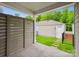 Covered patio with a view of the green lawn and detached garage, framed by a modern privacy screen at 10115 Mamillion Dr, Huntersville, NC 28078