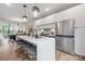 Bright kitchen features a large island with seating, stainless steel appliances, and sleek white cabinetry at 111 Verbena Ne St # 10, Charlotte, NC 28217