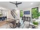 Inviting living room with large windows, a ceiling fan, modern furnishings, and a view of the staircase at 111 Verbena Ne St # 10, Charlotte, NC 28217