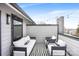A cozy patio featuring stylish seating arrangements, a modern privacy wall, and ambient string lights at 111 Verbena Ne St # 10, Charlotte, NC 28217
