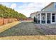 Expansive backyard with well-maintained lawn, a screened porch, and privacy fence at 1148 Mckee Farm Ln, Belmont, NC 28012