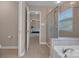 Bathroom with an open doorway, a glass door shower and a soaking tub with chrome fixtures at 1148 Mckee Farm Ln, Belmont, NC 28012