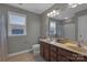 Well lit bathroom featuring a double vanity, framed mirror, and a shower/tub combo at 1148 Mckee Farm Ln, Belmont, NC 28012