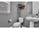 Stylish half-bath with modern fixtures, a decorative shelf, and a wall-mounted sink at 1148 Mckee Farm Ln, Belmont, NC 28012