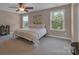 Inviting bedroom features carpet flooring, ceiling fan, and large windows at 1148 Mckee Farm Ln, Belmont, NC 28012