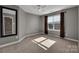 Spacious bedroom with a large window, neutral walls, and carpet flooring at 1148 Mckee Farm Ln, Belmont, NC 28012