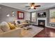 Inviting living room with fireplace, TV, and a comfortable seating arrangement at 1148 Mckee Farm Ln, Belmont, NC 28012