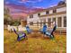 Backyard featuring a fire pit with chairs and an outdoor deck at 122 Lansdowne Rd, Charlotte, NC 28270