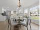 Bright dining area with chandelier, bay window, and open access to a modern white kitchen at 122 Lansdowne Rd, Charlotte, NC 28270