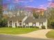 Charming two-story home with manicured lawn, a paved driveway, and classic architectural details at 122 Lansdowne Rd, Charlotte, NC 28270