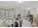 Spacious living room with tile floored sunroom and ample seating at 122 Lansdowne Rd, Charlotte, NC 28270