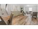 Open-concept living area featuring a fireplace, hardwood floors, and modern furnishings at 122 Lansdowne Rd, Charlotte, NC 28270