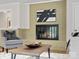 Cozy living room with a brick fireplace and hearth, modern art, and comfortable seating at 122 Lansdowne Rd, Charlotte, NC 28270