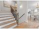 Staircase leading to the kitchen and dining area with wooden steps and modern railing at 122 Lansdowne Rd, Charlotte, NC 28270
