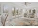 Bright sunroom with tile floors, ceiling fan, and multiple windows that offers ample natural light at 122 Lansdowne Rd, Charlotte, NC 28270