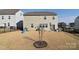Large backyard features a black metal fence, a small tree, and a seating area just outside the sliding door at 124 Doncaster Dr, Mooresville, NC 28115