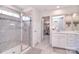 Bright bathroom featuring a glass-enclosed shower and an open doorway to a walk-in closet at 124 Doncaster Dr, Mooresville, NC 28115