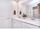 Bright bathroom featuring a double vanity, white cabinets, and a large mirror at 124 Doncaster Dr, Mooresville, NC 28115