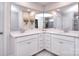 Bright bathroom featuring a double vanity, white cabinets, and a large mirror at 124 Doncaster Dr, Mooresville, NC 28115