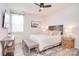 Cozy bedroom with a comfortable bed, a ceiling fan, and plenty of natural light at 124 Doncaster Dr, Mooresville, NC 28115