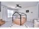 Cozy bedroom featuring a platform bed, ceiling fan, and a window at 124 Doncaster Dr, Mooresville, NC 28115