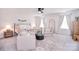 Bright bedroom with a cozy seating area, plush carpet, and plenty of natural light at 124 Doncaster Dr, Mooresville, NC 28115