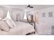 Well-lit bedroom featuring a bed, comfortable seating, and stylish furnishings at 124 Doncaster Dr, Mooresville, NC 28115